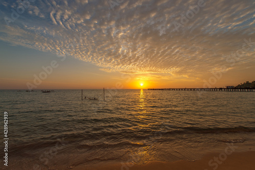 Romantic sky with colorful sunset over the sea background.