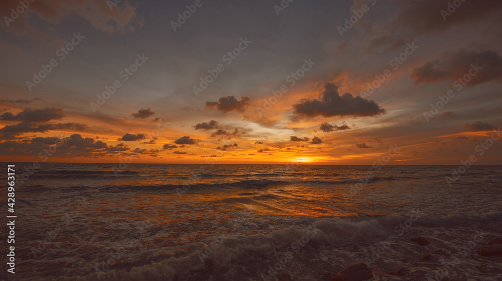 Romantic sky with colorful sunset over the sea background.