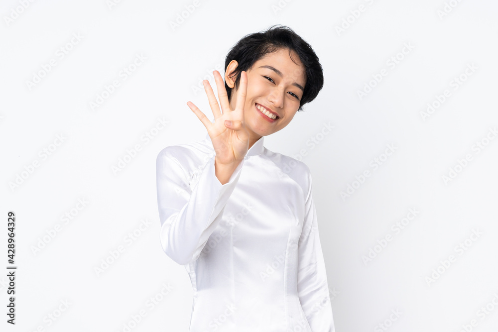 Young Vietnamese woman with short hair wearing a traditional dress over isolated white background happy and counting four with fingers Young Vietnamese woman with short hair wearing a traditional dress over isolated white background happy and counting four with fingers