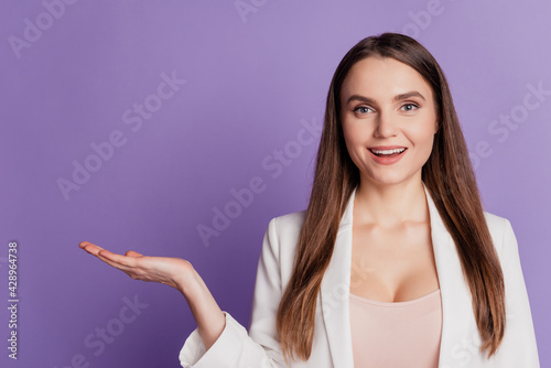 Close up portrait of lady hand hold empty space wear formal suit posing on violet wall