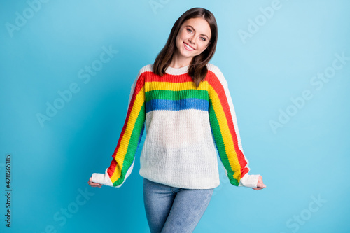 Photo of pretty girlish young woman dressed striped sweater smiling isolated blue color background