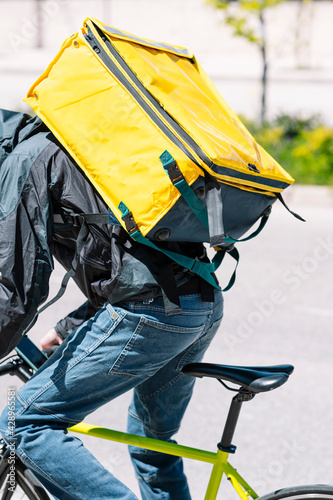 Unrecognizable man who works delivering food by courier to home.