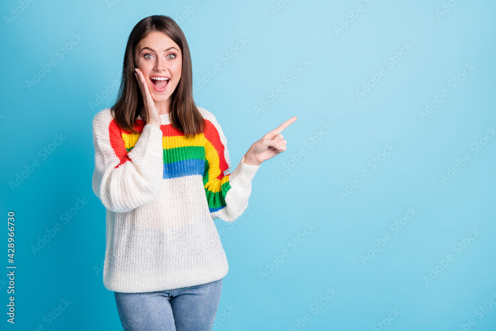 Portrait of attractive cheerful amazed girl demonstrating copy space ad look isolated over bright blue color background Portrait of attractive cheerful amazed girl demonstrating copy space ad look isolated over bright blue color background