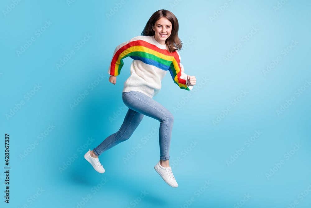 Full length body size view of pretty cheerful girl jumping running fast achievement isolated over bright blue color background
