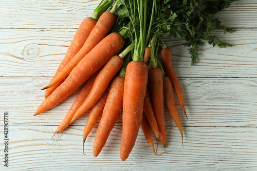 Heap of fresh carrot on white wooden table