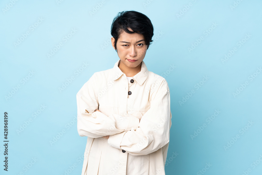 Young Vietnamese woman with short hair over isolated background feeling upset Young Vietnamese woman with short hair over isolated background feeling upset