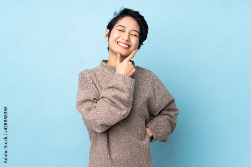Young Vietnamese woman with short hair over isolated background happy and smiling Young Vietnamese woman with short hair over isolated background happy and smiling