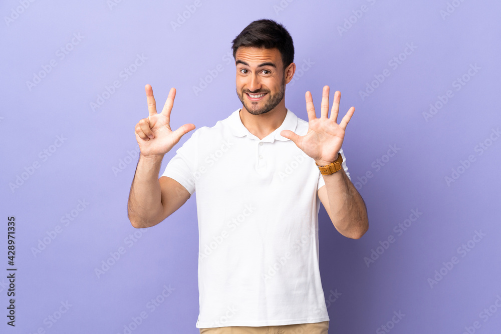 Young handsome man isolated on purple background counting eight with fingers