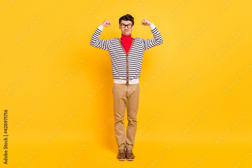 Fototapeta premium Full length photo of young guy sportive show hands muscles biceps triceps isolated over yellow color background