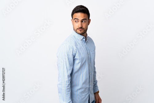 Young handsome man over isolated background . Portrait
