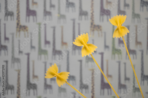 Photography Butterfly noodles against a background with giraffes