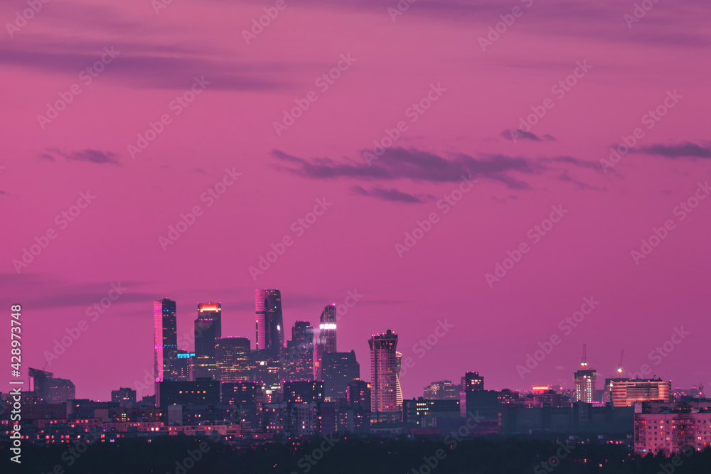 Pink sky over city buildings with towers of skyscrapers Moscow city