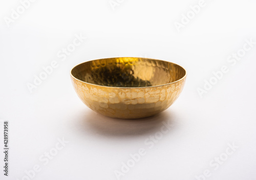 empty crockery - New brass or gold bowl over white background photo