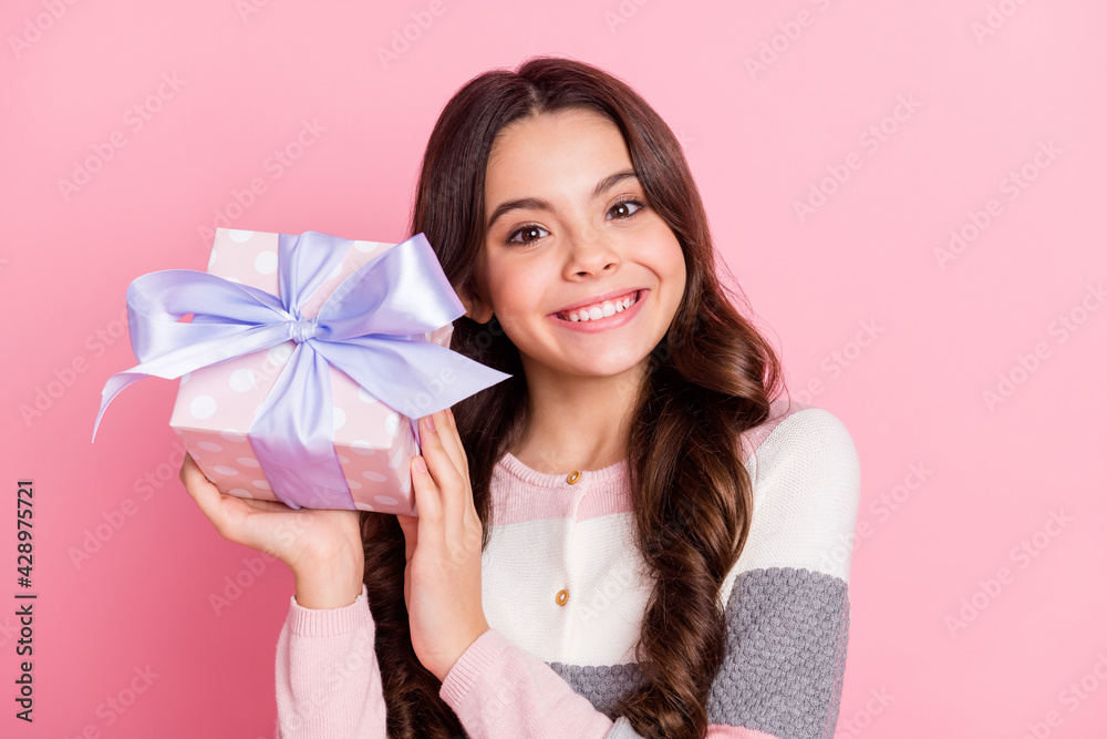 Photo of young attractive girl happy positive smile shake present box holiday celebration isolated over pastel color background Photo of young attractive girl happy positive smile shake present box holiday celebration isolated over pastel color background