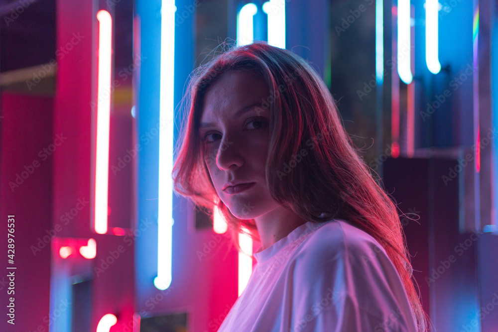 Neon model poses. Young model in colourful light Stock Photo | Adobe Stock