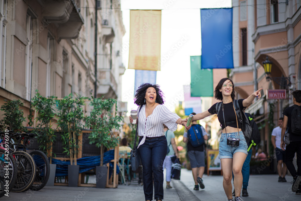 Fototapeta premium Two tourist women on street.