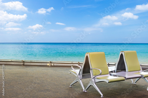 Fototapeta Naklejka Na Ścianę i Meble -  Airport chair at waiting area with beautiful beach view, holiday destination, summer vacation