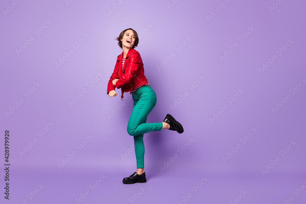 Full size profile side photo of young girl happy positive smile have fun dance look empty space isolated over purple color background