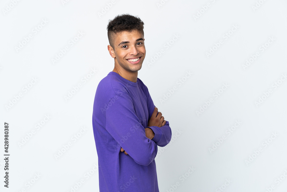 Young brazilian man isolated on white background looking to the side and smiling Young brazilian man isolated on white background looking to the side and smiling