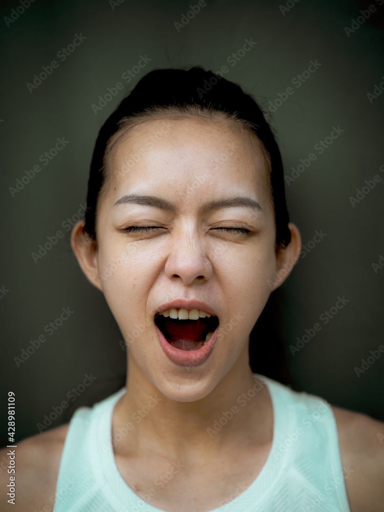 Beautiful young Asian woman doing face yoga poses Beautiful young Asian woman doing face yoga poses