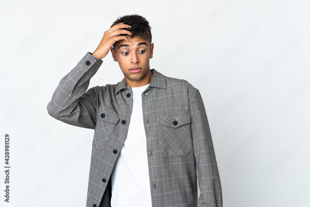 Young brazilian man isolated on white background doing surprise gesture while looking to the side Young brazilian man isolated on white background doing surprise gesture while looking to the side