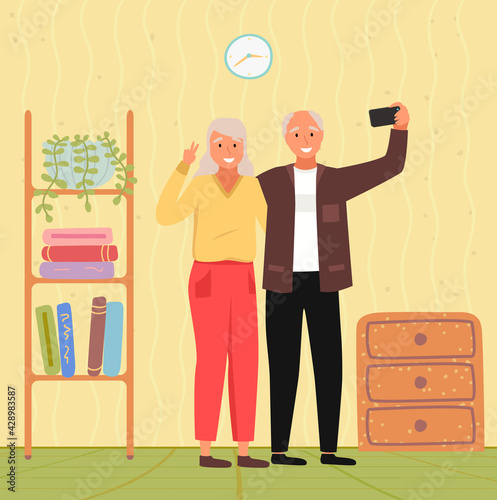 Elderly couple holding mobile phone and taking pictures. Woman smiling and posing for photo