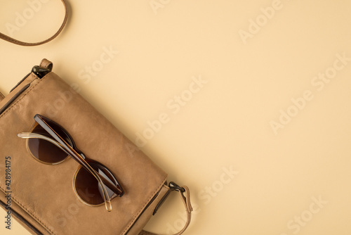 Billede på lærred Top view photo of leather bag satchel on isolated beige background with copyspac