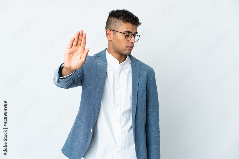 Young business Brazilian man isolated on white background making stop gesture and disappointed