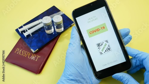 Vaccination passport on a mobile phone allowing travel in hand. Vaccination against the coronavirus Covid 19.Imunity or Health passport, closeup photo