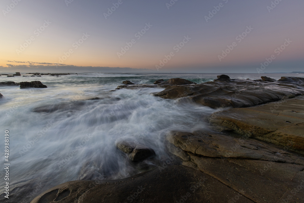 Water flowing into the rock platform at the coastline.