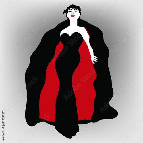 A glamorous woman wears a stylish gown and cape.