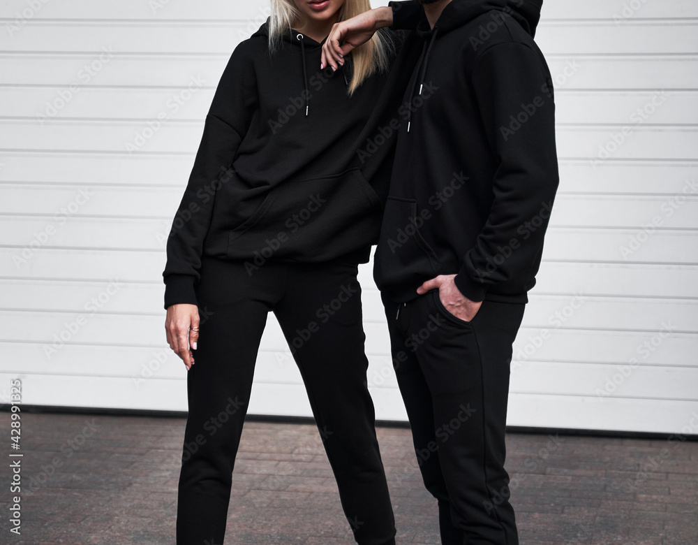 Woman and man wear black hoodie without a logo. No logo basic sportswear.  Long sleeve sweatshirt mockup Stock Photo | Adobe Stock