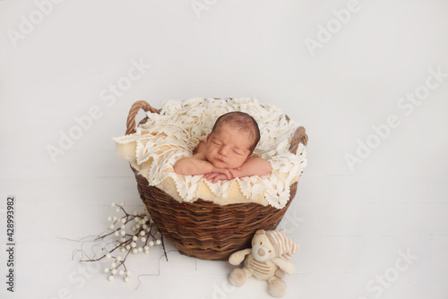 Photo of newborn baby sleeping at home. First days of life 
