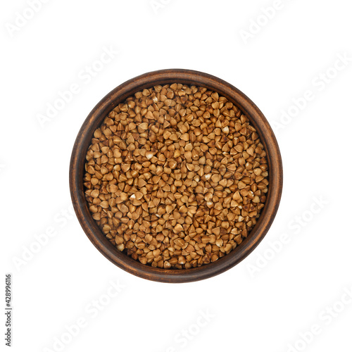 buckwheat grain in clay bowl isolated on white background, top view