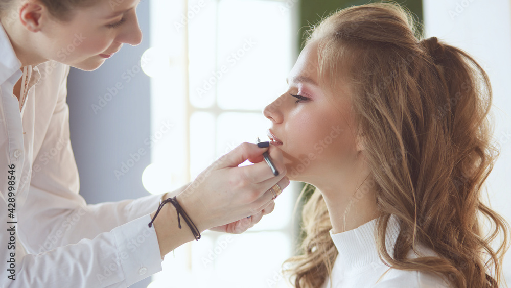 beautiful young model woman getting fashion make-up beautiful young model woman getting fashion make-up
