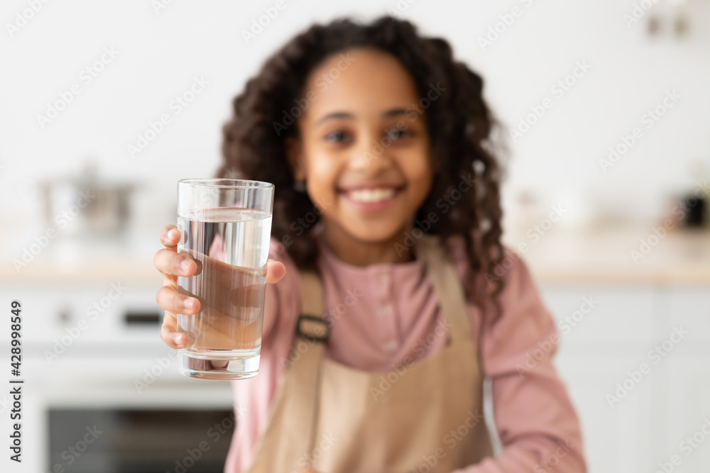 African American curly girl holding glass of water African American curly girl holding glass of water
