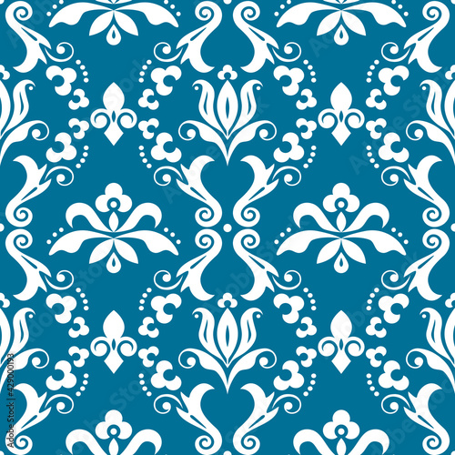 Damask elegant vector seamless pattern, victorian textile or fabric print design with flowers, swirls and leaves in white on turquoise

