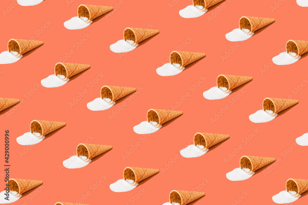A cone with melted ice cream on a bright red background. Minimalistic summer food concept