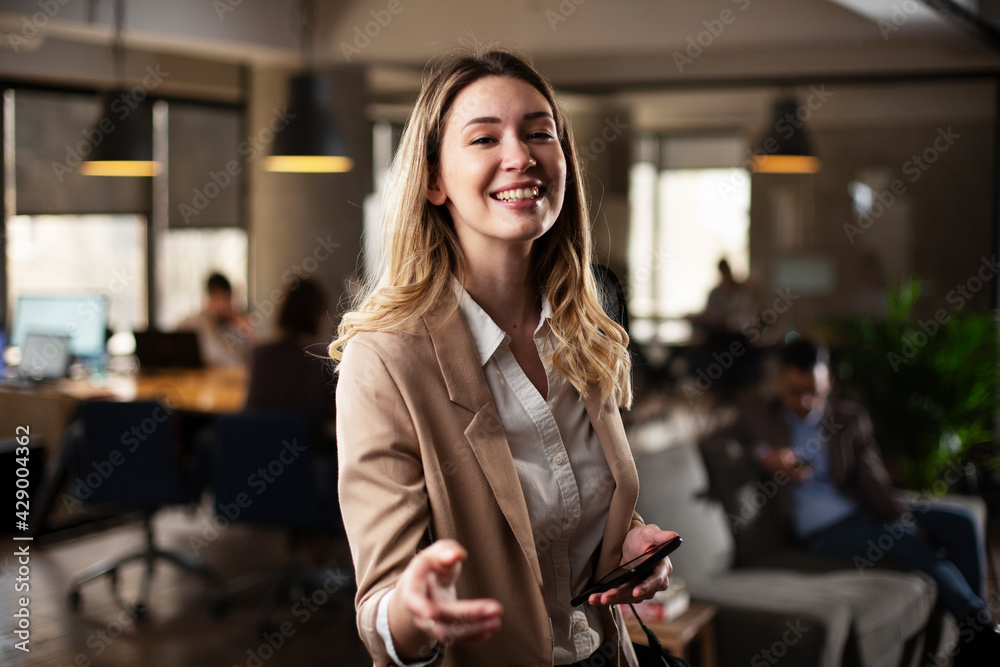 Businesswoman in office. Smiling businesswoman using the phone.