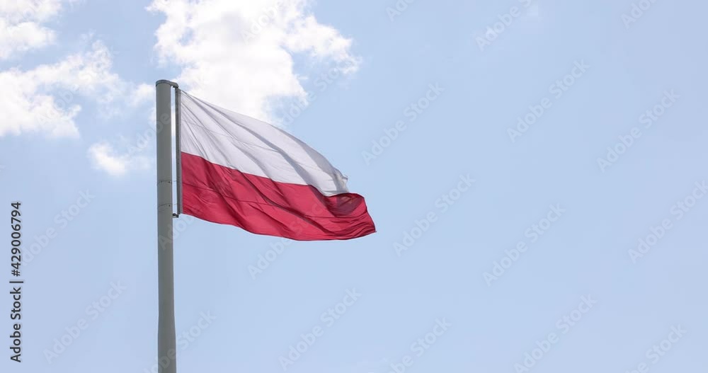 Polish flag on the mast. Beautiful Polish flag waving in a strong wind. Polish flag on the mast. Beautiful Polish flag waving in a strong wind.