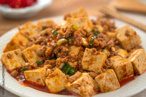 Mapo tofu. Stir-fried tofu with hot spicy sauce in white plate.