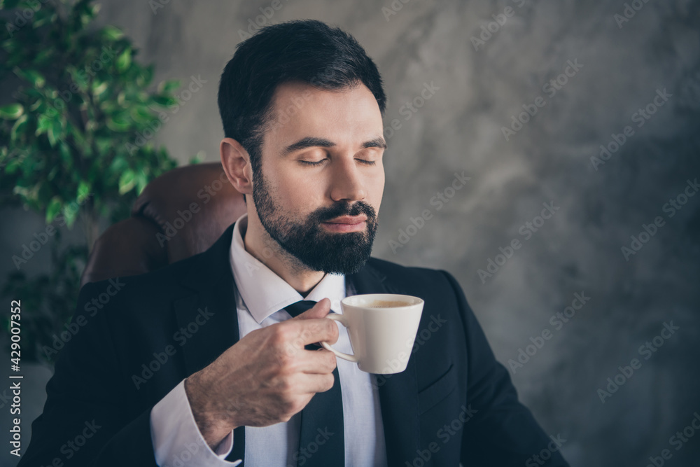 Photo of relaxed cool businessman hold mug smell coffee aroma wear suit shirt tie in modern office indoors Photo of relaxed cool businessman hold mug smell coffee aroma wear suit shirt tie in modern office indoors