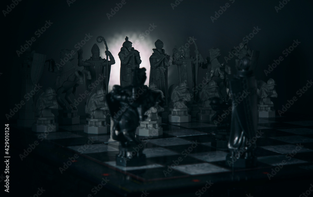 Chess pieces on a blackboard in a dark style