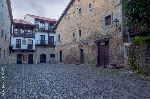 Medieval and lonely street with cobbled floor in the famous and touristic town of Santillana del Mar, in the Cantabria region of Spain