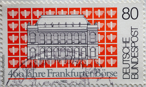 GERMANY - CIRCA 1985 : a postage stamp from Germany, showing the building of the international Frankfurt Stock Exchange in front of a tiled background with the emblem. 400 years photo