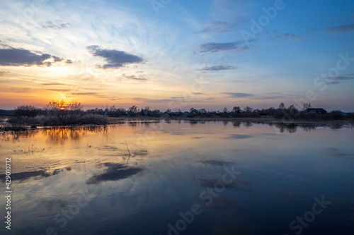 Sunset river quiet landscape view. Evening by the river. Sunset meditation. Romantic evening. The sun is low over the river.