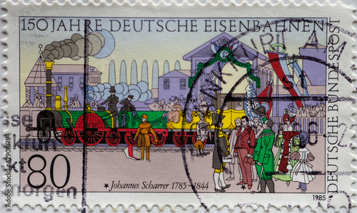 a postage stamp from Germany  showing the first journey of the historic Adler s train on the Ludwigseisenbahn. 150 years of the German railways and 200 years of Johannes Scharrer