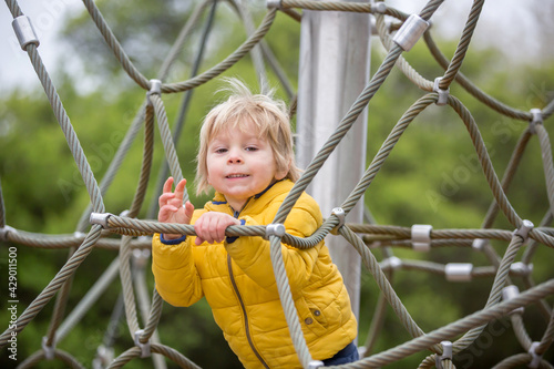 Cute toddler boy, playing on the playground