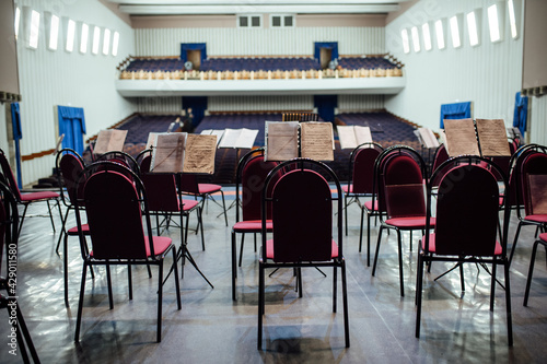 view of the empty concert hall from the stage. on the stage there are chairs and instruments for the musicians. preparation of the philharmonic for the performance of the famous orchestra