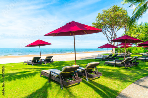 beach chair and umbrella with sea beach background © topntp